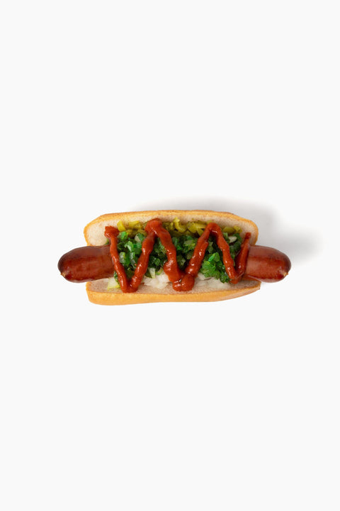 Gluten-free hot dog with toppings on a soft gluten-free bun