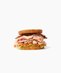 Gluten-free turkey club sandwich stacked with fresh ingredients