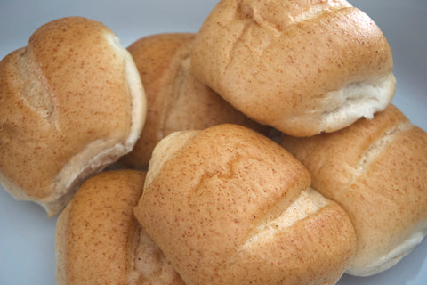 Close-up of gluten-free oat dinner rolls from Outside The Breadbox showing golden crust and shape