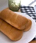Gluten-free oat sandwich rolls from Outside The Breadbox shown on a plate, highlighting soft texture and golden crust