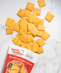 Gluten-free jalapeño cheddar crackers from Outside The Breadbox with crackers scattered next to the package