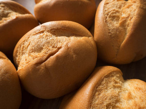 Close-up of gluten-free brown rice dinner rolls with a soft golden crust