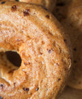 Close-up of gluten-free oat cheddar bagels from Outside The Breadbox showing toasted crust and texture