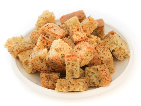 Bowl of gluten-free croutons showing lightly toasted texture and herb seasoning