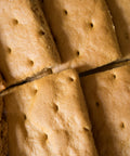 Close-up of gluten-free graham crackers from Outside The Breadbox, showing baked texture and perforated tops